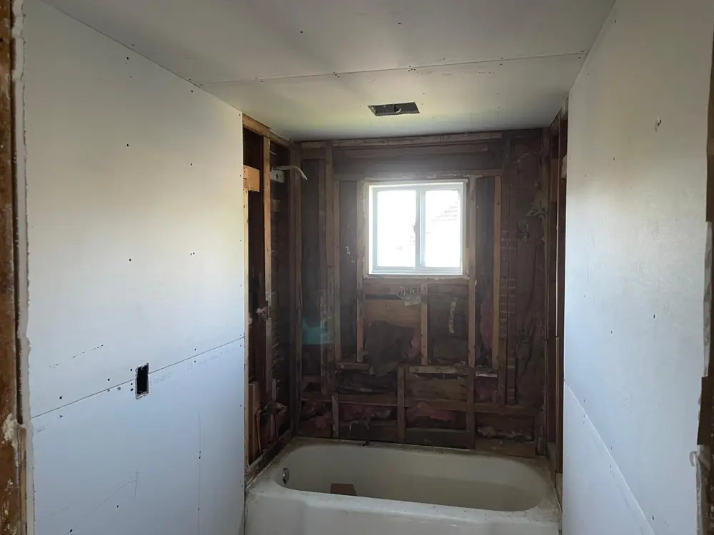 Bathroom walls boarded around a new tub