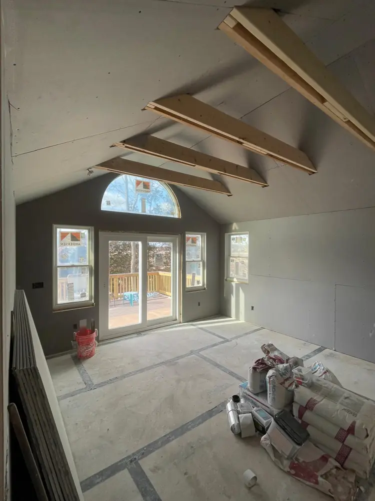 Cathedral room with arched window, drywall hung